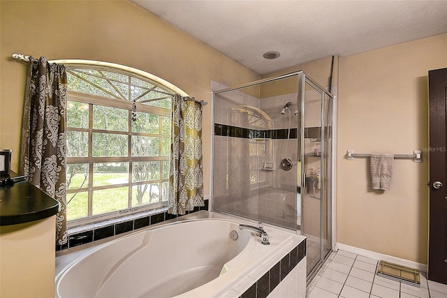 bathroom featuring independent shower and bath, a textured ceiling, and tile floors