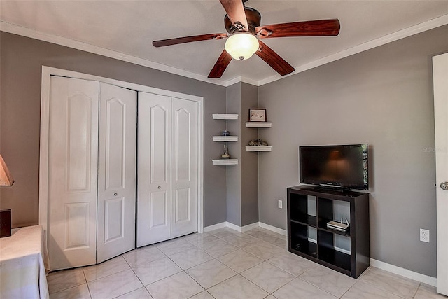 interior space with ornamental molding, a closet, ceiling fan, and light tile floors