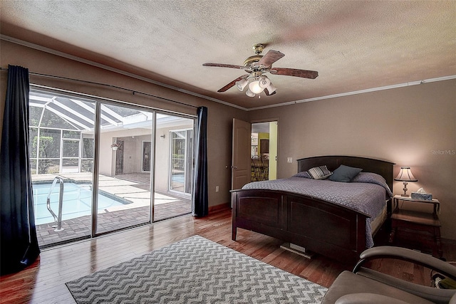 bedroom featuring ceiling fan, dark wood-type flooring, a textured ceiling, access to outside, and ornamental molding