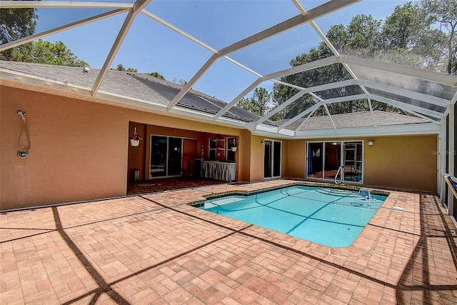 view of pool with a patio and a lanai