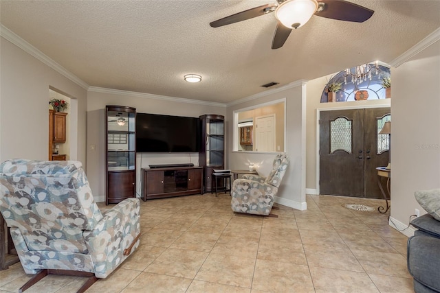 tiled living room with ceiling fan, ornamental molding, and a textured ceiling