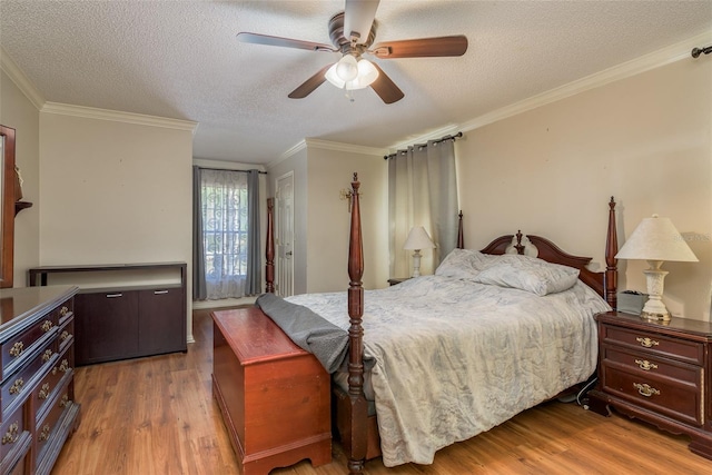 bedroom with crown molding, ceiling fan, wood-type flooring, and a textured ceiling