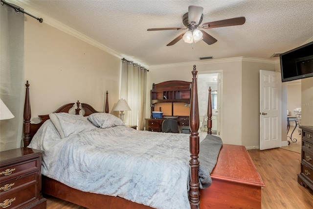 bedroom featuring a textured ceiling, light hardwood / wood-style flooring, ornamental molding, and ceiling fan