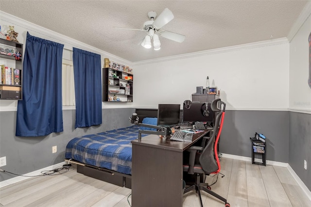 bedroom featuring crown molding, ceiling fan, wood-type flooring, and a textured ceiling