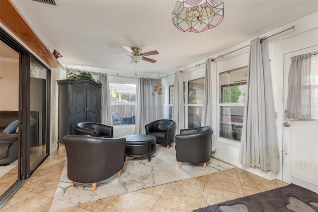 interior space with ceiling fan and light tile patterned flooring