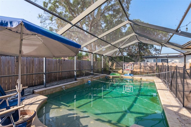 view of pool with glass enclosure