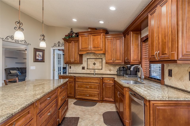 kitchen featuring lofted ceiling, sink, decorative light fixtures, dishwasher, and light stone countertops