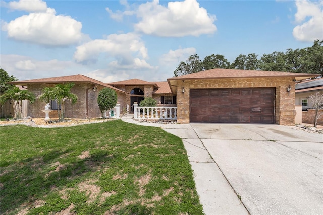 single story home featuring a garage and a front yard