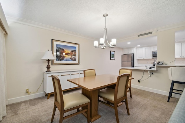 dining room featuring an inviting chandelier, light carpet, crown molding, and a textured ceiling