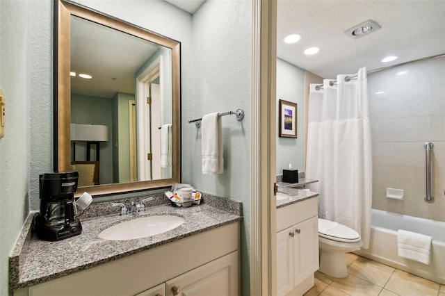 full bathroom featuring vanity with extensive cabinet space, shower / bath combination with curtain, tile floors, toilet, and a textured ceiling