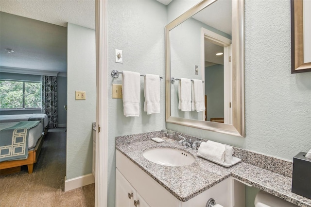 bathroom featuring a textured ceiling and large vanity