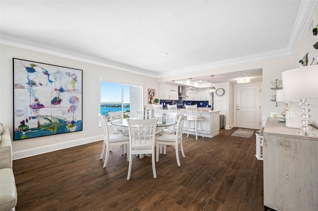 dining room featuring a water view, dark wood-type flooring, and ornamental molding