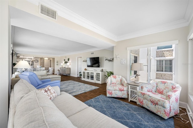 living room featuring dark hardwood / wood-style flooring and ornamental molding