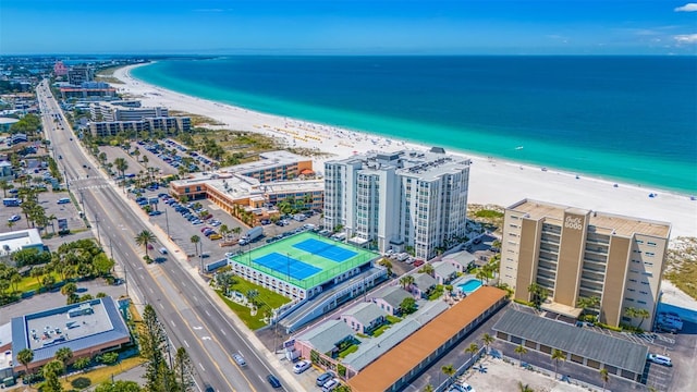 drone / aerial view featuring a water view and a view of the beach