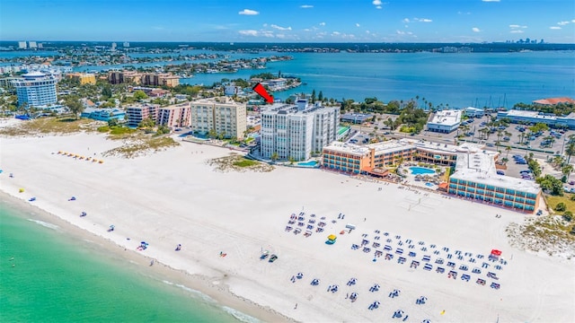 birds eye view of property featuring a water view and a beach view