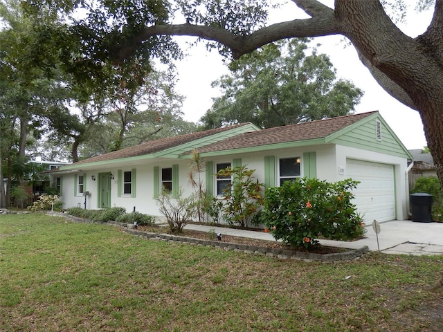 ranch-style home featuring a garage and a front yard