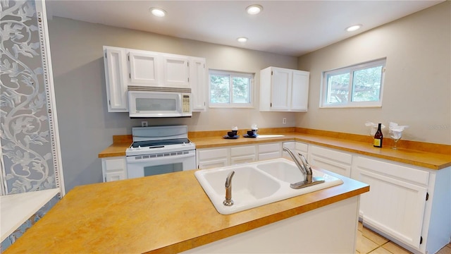 kitchen with recessed lighting, white appliances, a sink, white cabinets, and light countertops