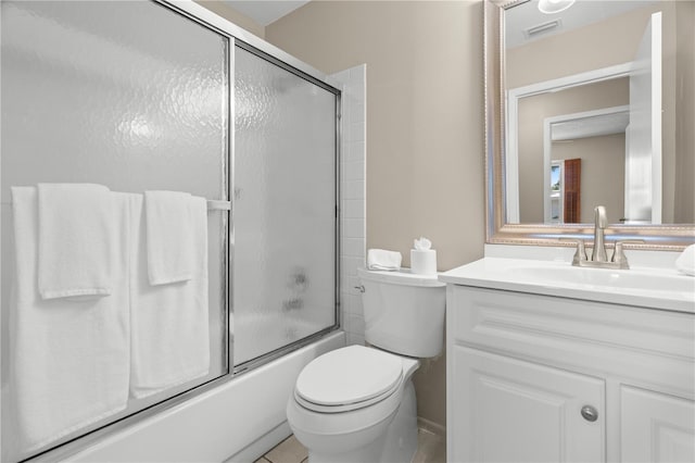 bathroom featuring toilet, visible vents, combined bath / shower with glass door, and vanity