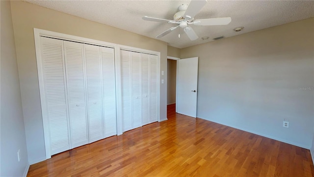 unfurnished bedroom with light wood-style floors, visible vents, and a textured ceiling