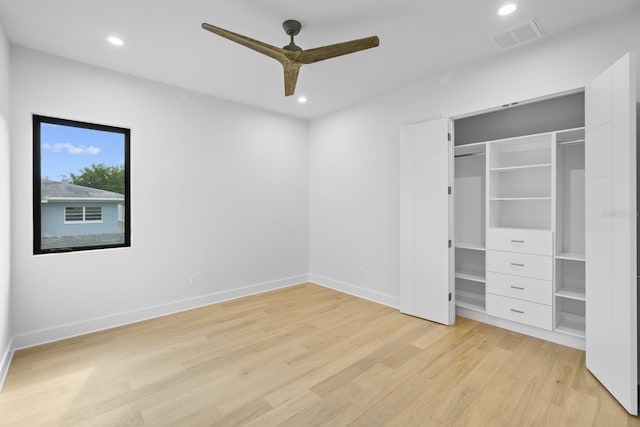 unfurnished bedroom featuring ceiling fan, a closet, and light wood-type flooring