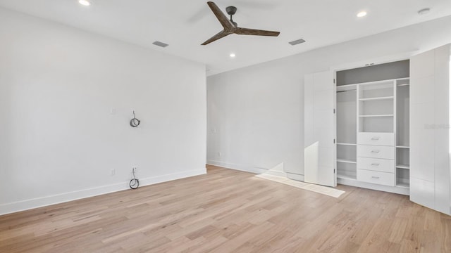 unfurnished bedroom featuring light hardwood / wood-style floors, a closet, and ceiling fan