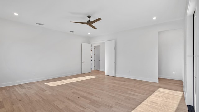 empty room featuring light wood-type flooring and ceiling fan