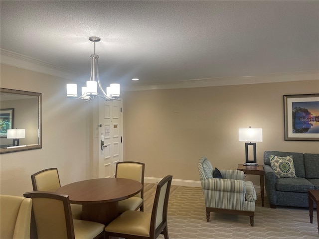 dining room featuring a notable chandelier, a textured ceiling, and ornamental molding