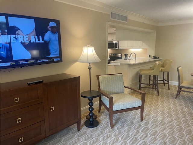 sitting room featuring crown molding and light colored carpet