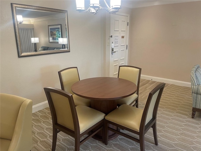 dining space with crown molding and a chandelier