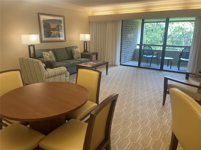 dining area with carpet and ornamental molding