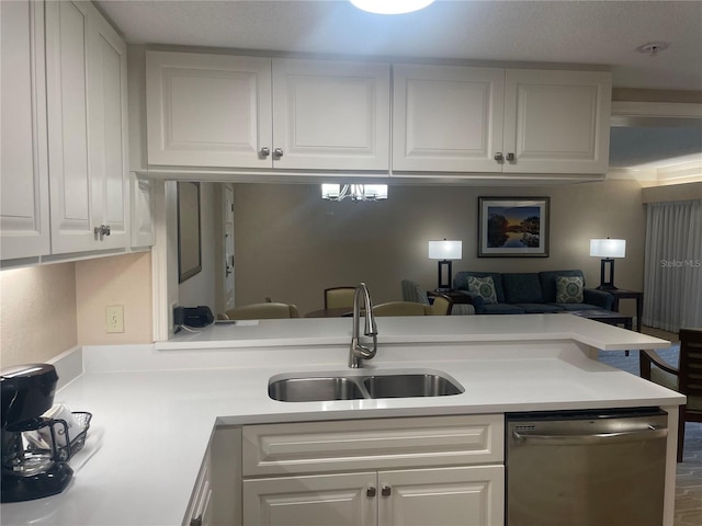 kitchen with sink, dishwasher, and white cabinetry