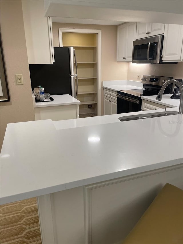 kitchen with appliances with stainless steel finishes and white cabinetry