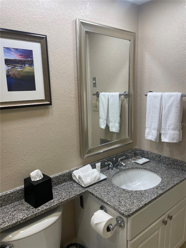 bathroom featuring large vanity and toilet