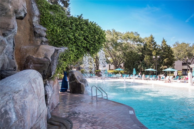 view of swimming pool featuring pool water feature