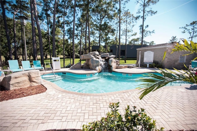 view of swimming pool with a hot tub and a patio