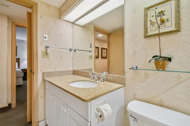 bathroom with vanity and toilet