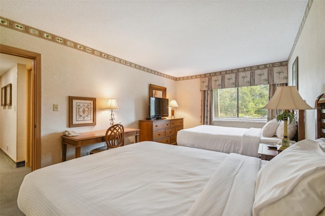 bedroom featuring carpet floors and a textured ceiling