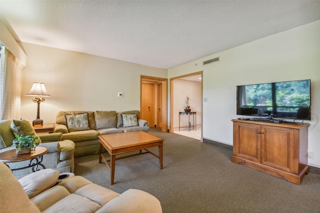 carpeted living room with a textured ceiling