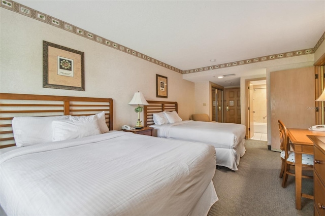 bedroom featuring carpet and ensuite bathroom