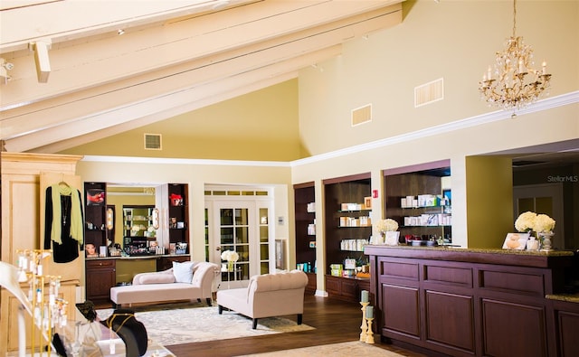 living room featuring hardwood / wood-style flooring, beam ceiling, a chandelier, and high vaulted ceiling