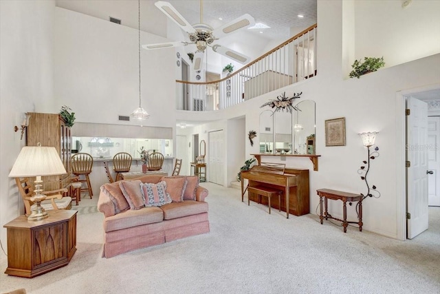 living room featuring a high ceiling, ceiling fan, and carpet floors