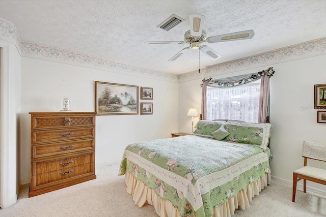 bedroom featuring a textured ceiling, ceiling fan, and carpet flooring