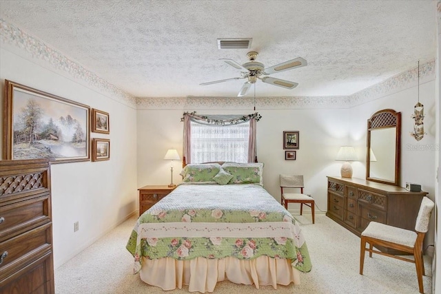 bedroom featuring a textured ceiling, ceiling fan, and carpet