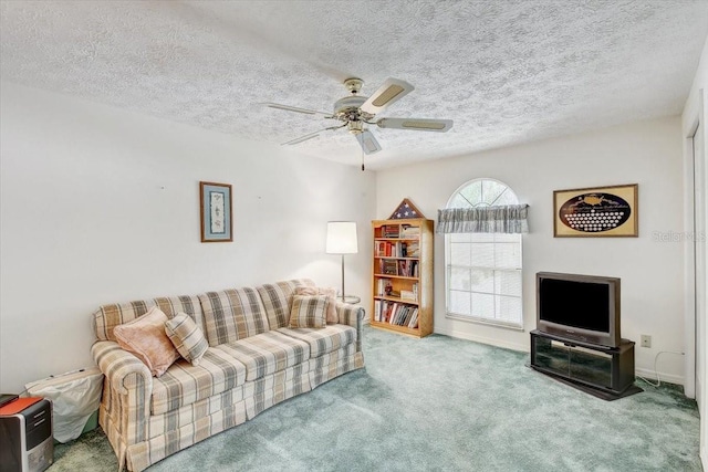 living room featuring ceiling fan, carpet, and a textured ceiling