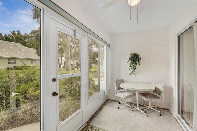 sunroom / solarium featuring ceiling fan and a healthy amount of sunlight