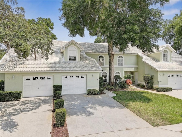 view of front of home featuring a garage and a front yard