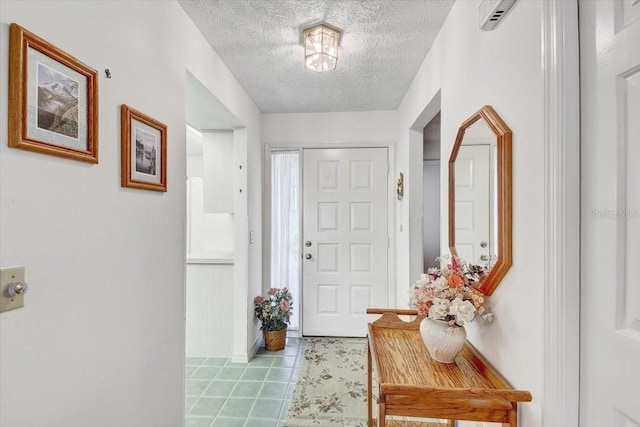 tiled entrance foyer with a textured ceiling