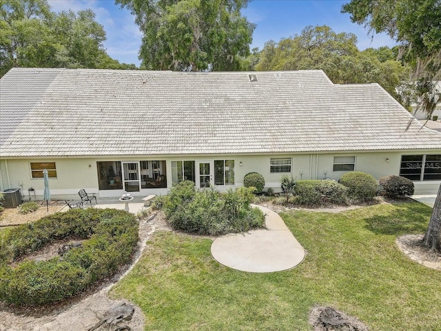 view of front of house featuring central AC unit and a front lawn