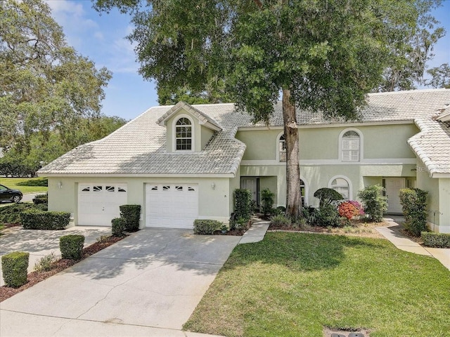 view of front of home featuring a garage and a front lawn