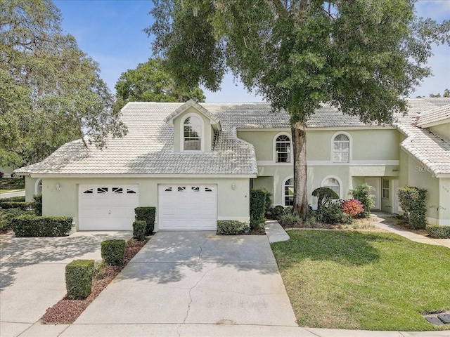 view of front of house with a front lawn and a garage